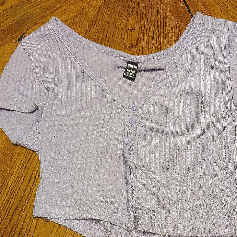 A purple button up crop top